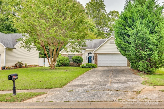 ranch-style home with a garage and a front yard