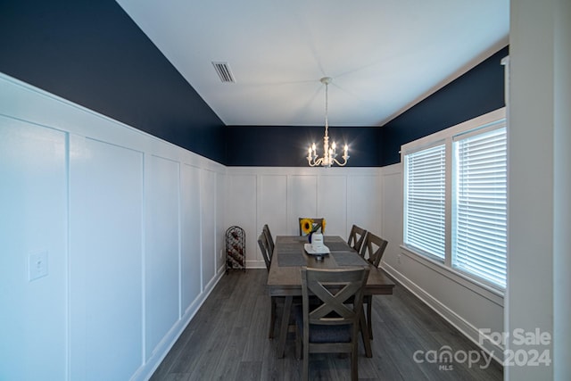 dining room featuring a chandelier and dark hardwood / wood-style floors