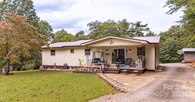 view of front of property with covered porch and a front yard