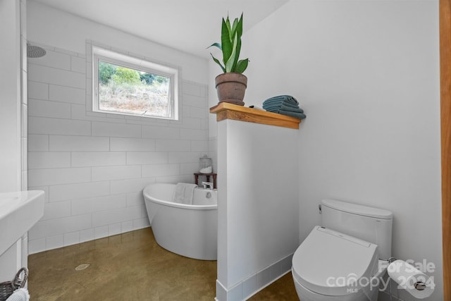 44 Brookside Dr, Burnsville, NC 28714 - full bath with a freestanding tub, tile walls, tiled shower, toilet, and finished concrete flooring