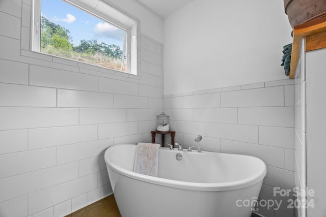 44 Brookside Dr, Burnsville, NC 28714 - bathroom featuring tile walls and a freestanding bath