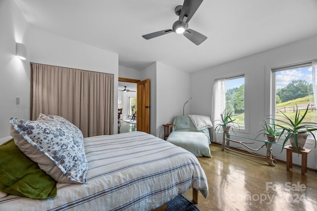 bedroom featuring concrete floors and ceiling fan