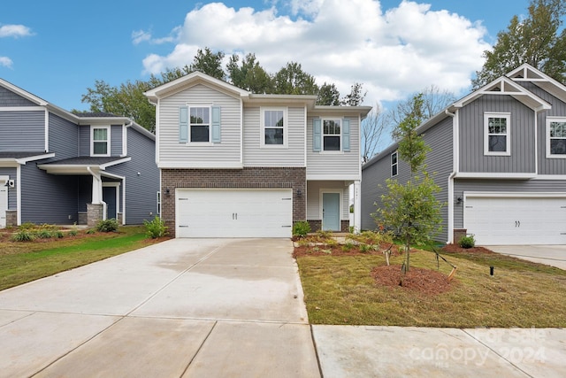 view of front of property featuring a front yard and a garage