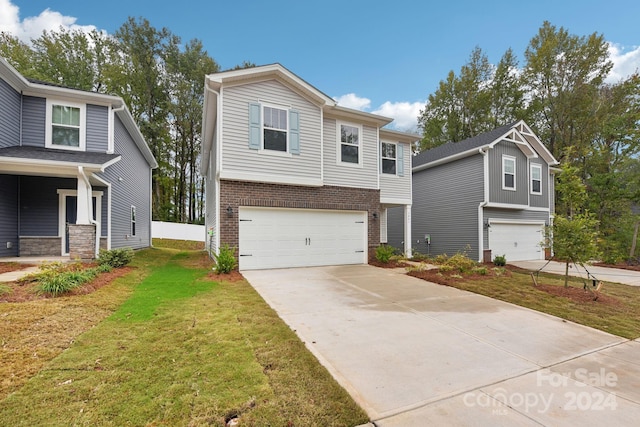 view of front of property with a front yard and a garage