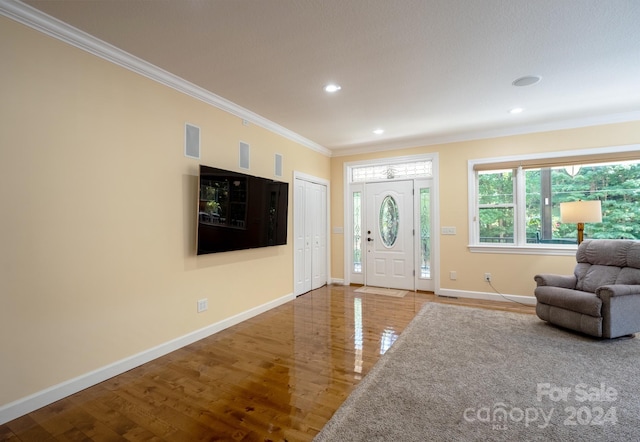 foyer featuring ornamental molding and hardwood / wood-style flooring