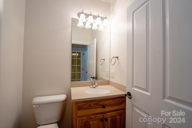 bathroom with toilet and vanity