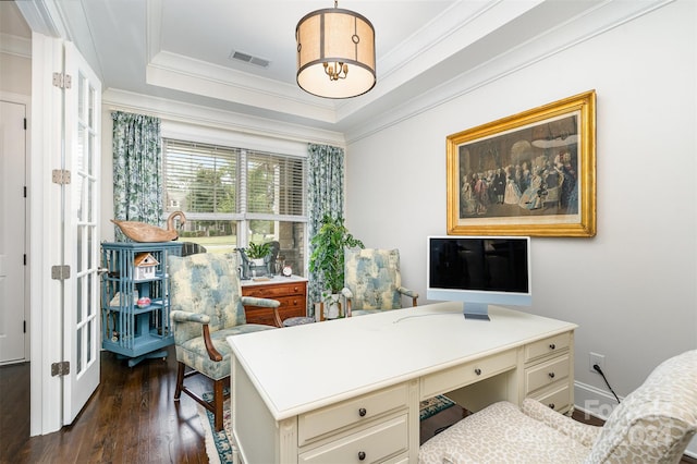 office area with dark wood-type flooring, a raised ceiling, and ornamental molding