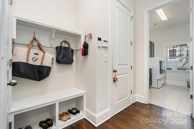 mudroom with wood-type flooring and washer and clothes dryer