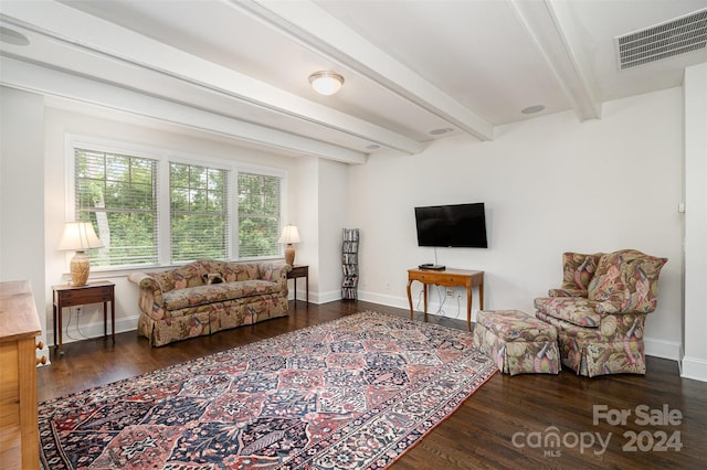 living room with dark hardwood / wood-style flooring and beam ceiling