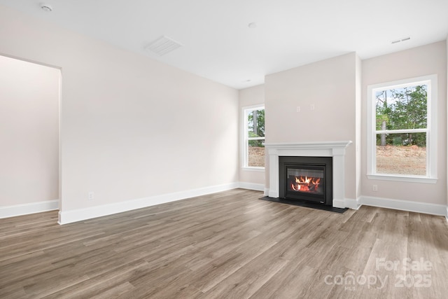 unfurnished living room featuring hardwood / wood-style floors