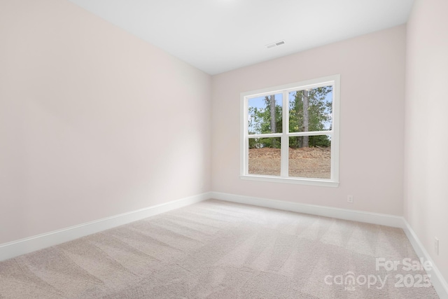 empty room featuring light carpet