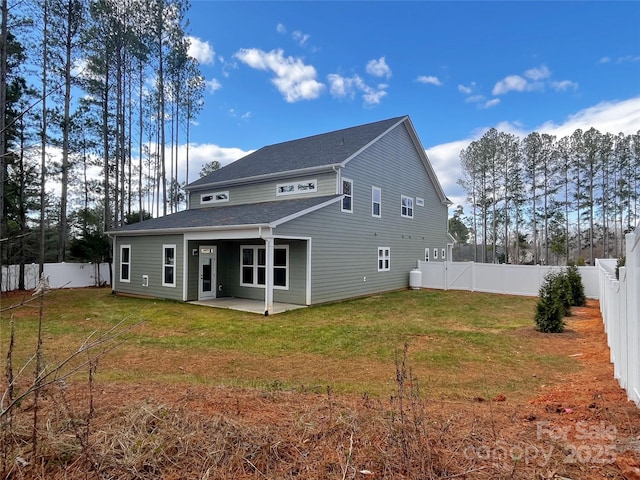 back of property with a lawn and a patio area