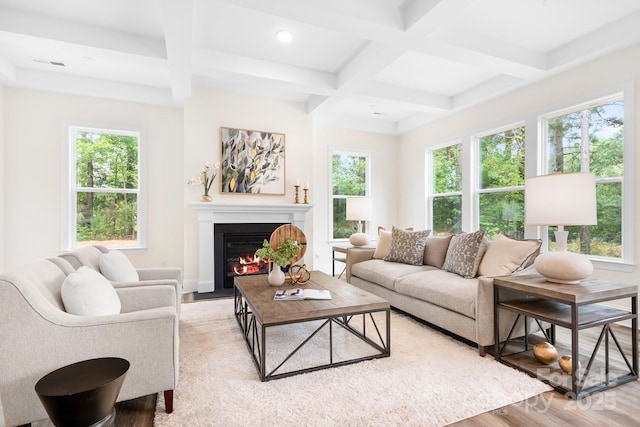 living room with a wealth of natural light, light hardwood / wood-style flooring, beamed ceiling, and coffered ceiling