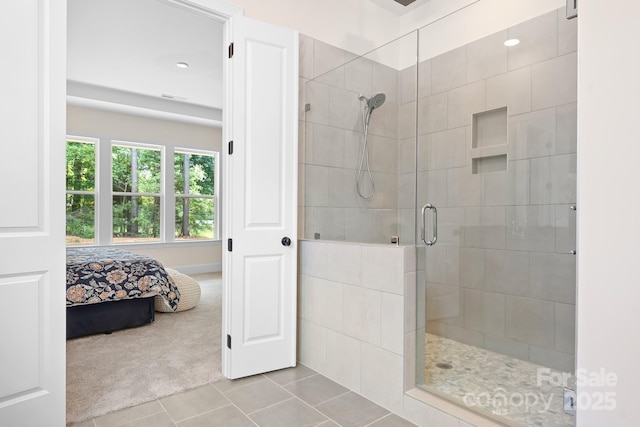 bathroom with tile patterned flooring and a shower with door