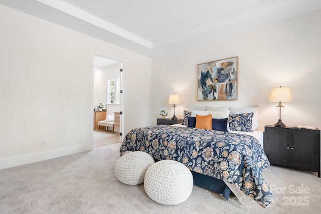 bedroom with light carpet and connected bathroom