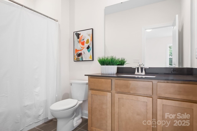 bathroom featuring tile patterned flooring, vanity, and toilet