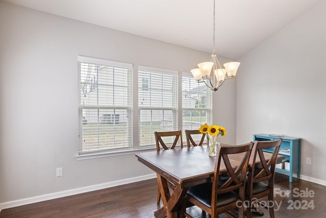 dining area with a notable chandelier, a healthy amount of sunlight, vaulted ceiling, and dark hardwood / wood-style flooring