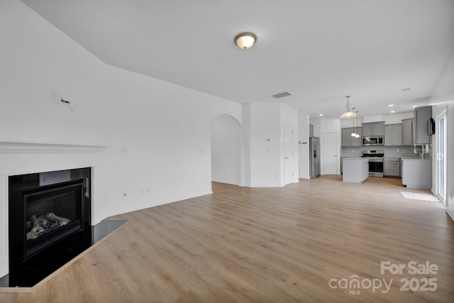 unfurnished living room featuring light wood-type flooring