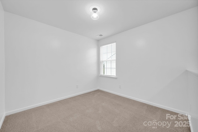 unfurnished room featuring carpet