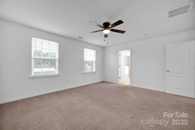 carpeted spare room with ceiling fan