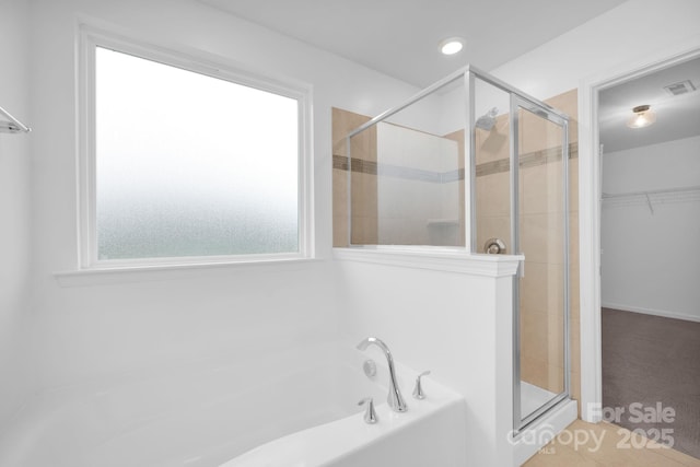 bathroom with shower with separate bathtub