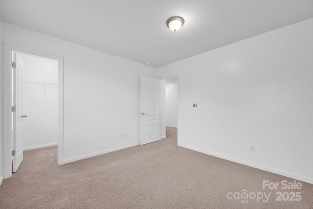 spare room featuring light carpet