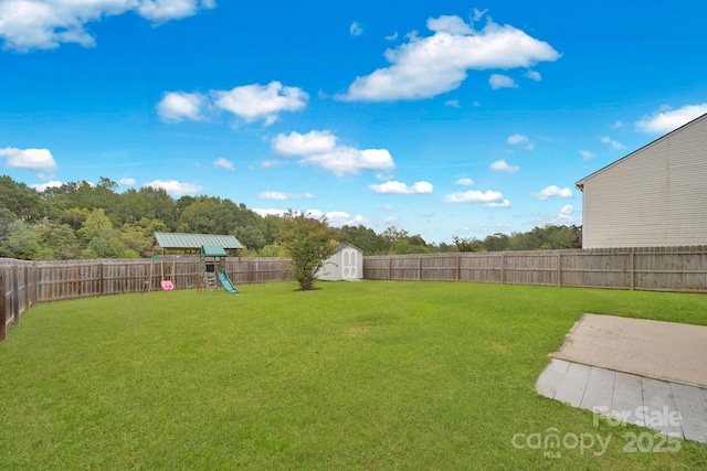 view of yard with a playground and a storage unit