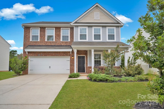 view of front of property featuring a front lawn and a garage