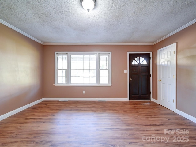 entryway featuring a textured ceiling, hardwood / wood-style flooring, and crown molding