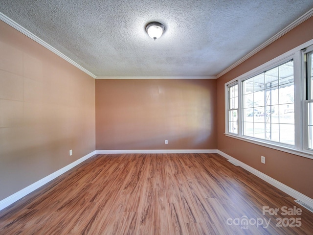 unfurnished room with wood-type flooring, a textured ceiling, and ornamental molding