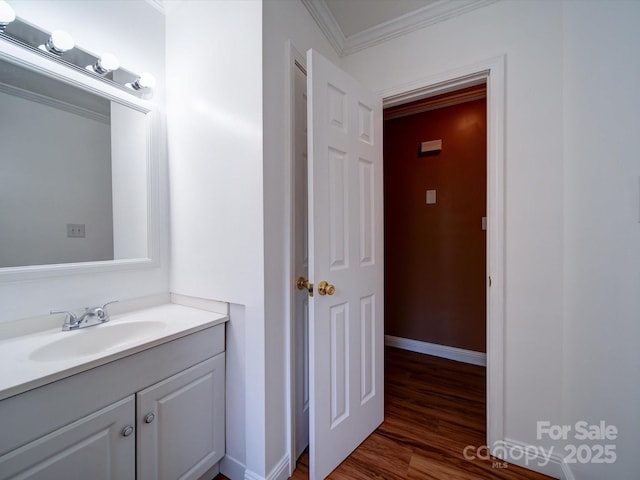 bathroom with vanity, wood-type flooring, and ornamental molding