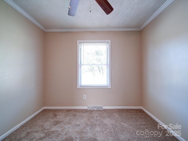 empty room with a textured ceiling, carpet floors, ceiling fan, and ornamental molding