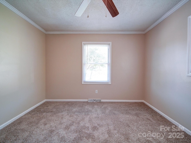 unfurnished room featuring light carpet, ceiling fan, a textured ceiling, and ornamental molding