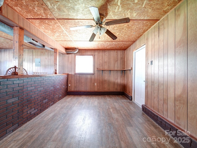 empty room featuring hardwood / wood-style flooring, wooden ceiling, and wood walls