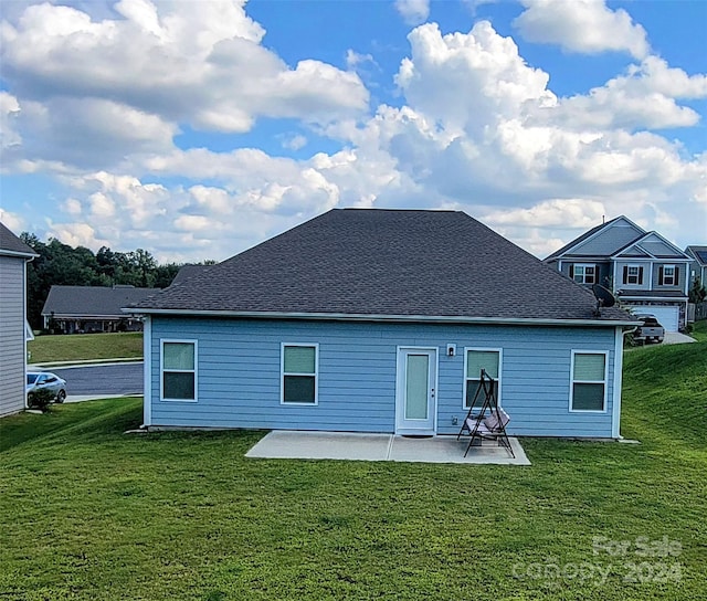 rear view of property with a lawn and a patio area