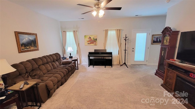 carpeted living room featuring ceiling fan and a wealth of natural light