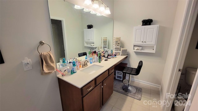 bathroom with tile patterned flooring, vanity, and toilet