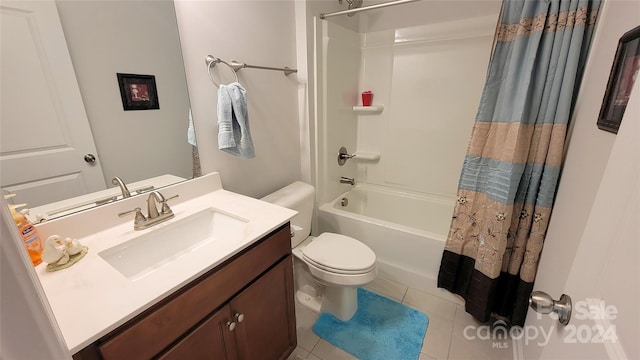 full bathroom with vanity, shower / bath combo with shower curtain, toilet, and tile patterned flooring