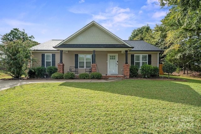 craftsman-style house with a front lawn and covered porch