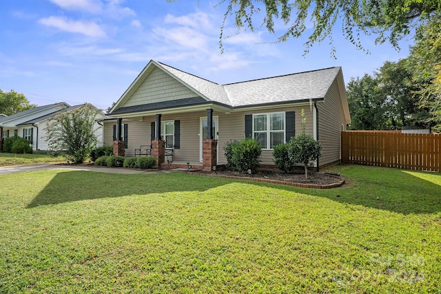 view of front of property with a porch and a front lawn