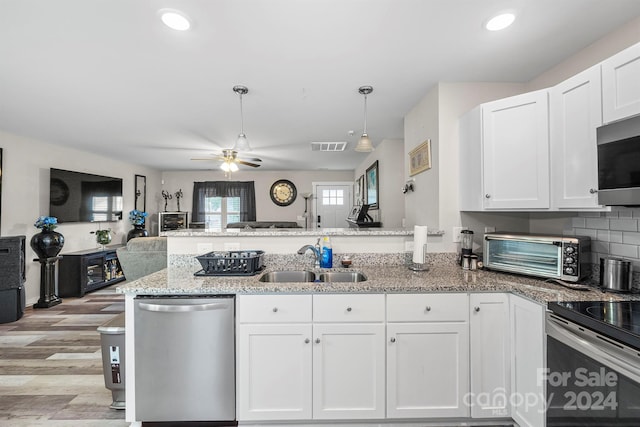 kitchen featuring ceiling fan, sink, appliances with stainless steel finishes, and white cabinetry