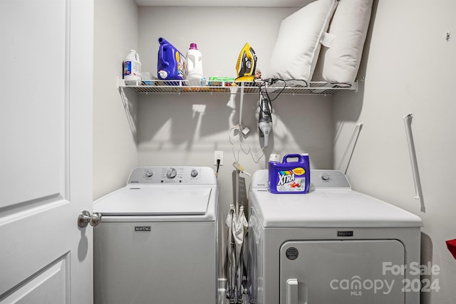 clothes washing area featuring washing machine and dryer