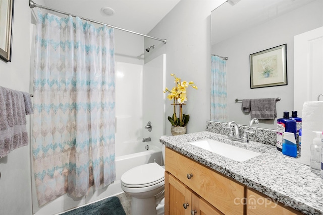 full bathroom featuring shower / bath combo with shower curtain, toilet, and vanity