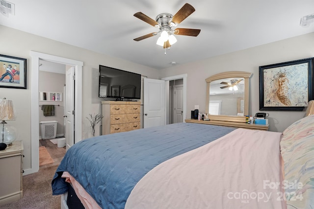 carpeted bedroom with ceiling fan and ensuite bath