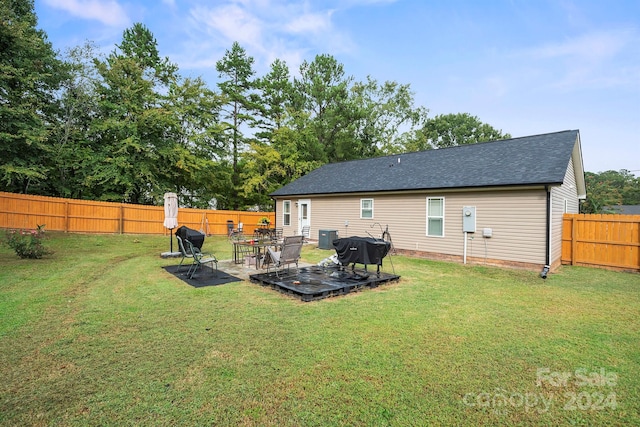 rear view of property with a lawn and a patio