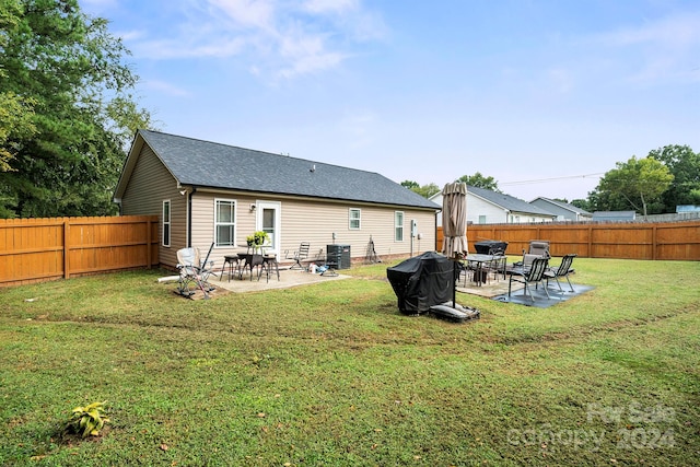 back of house featuring a yard, cooling unit, and a patio area