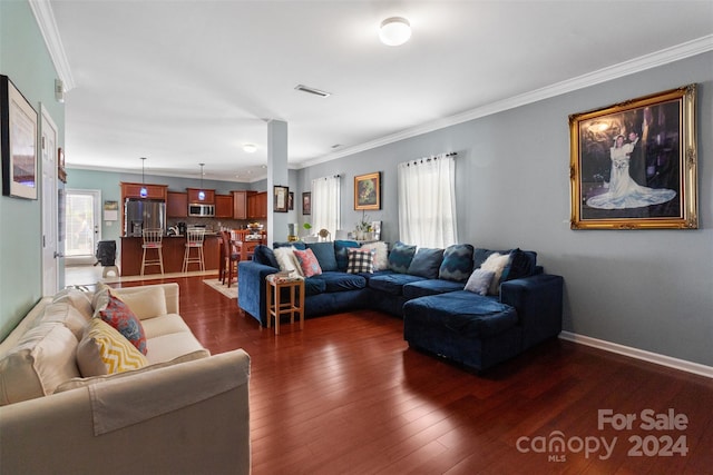 living room with dark wood-type flooring and crown molding