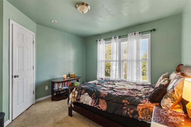 bedroom featuring light carpet