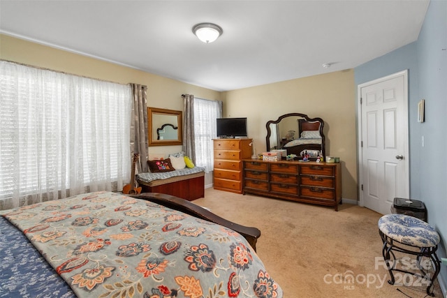 bedroom featuring light carpet