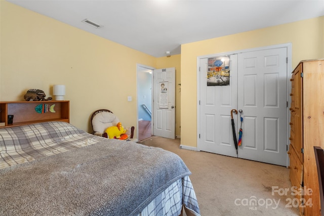 carpeted bedroom with a closet